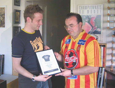 Kieran presents Frank with a plaque